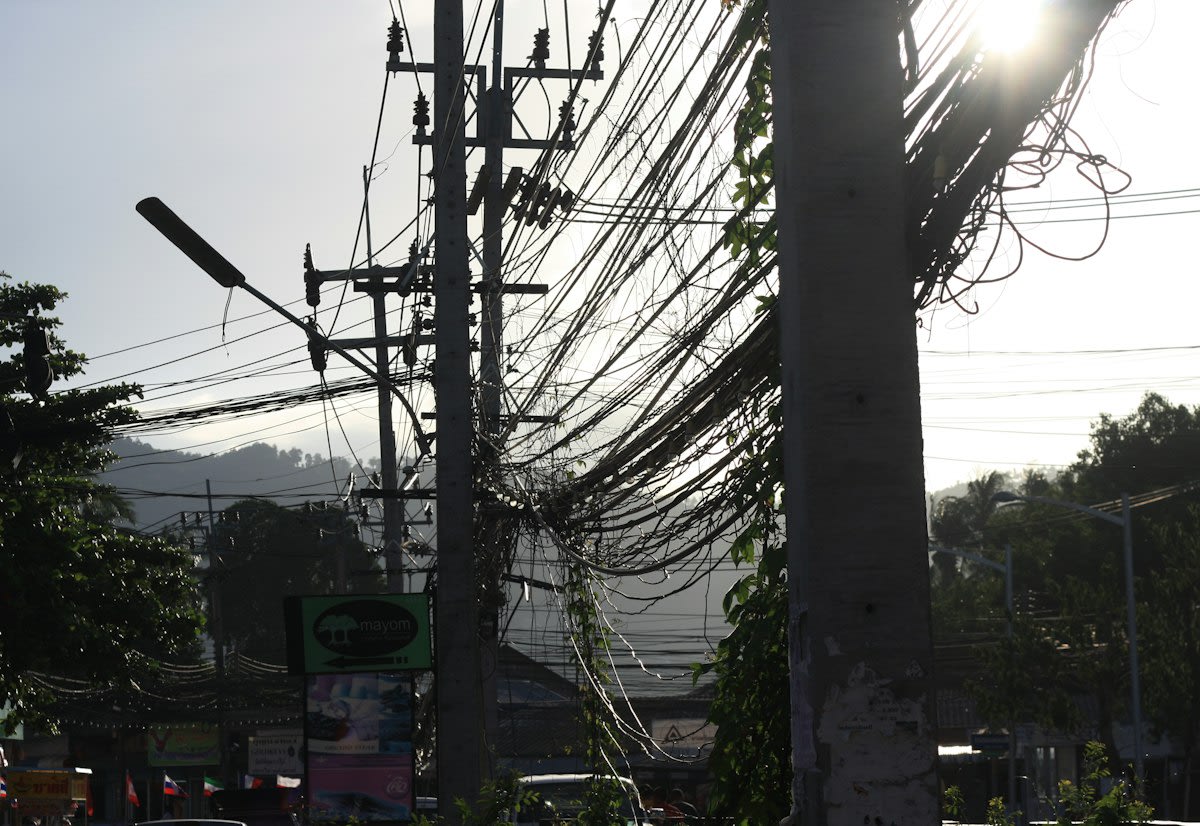 Overcrowded urban street with messy power lines