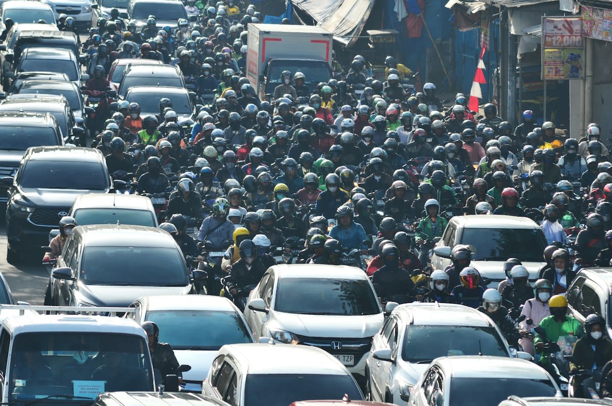 Jakarta crowded street with motorbikes and dense housing