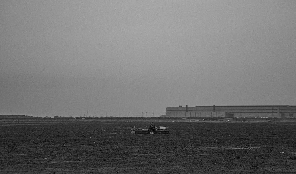 Industrial agricultural wasteland with rusted machinery