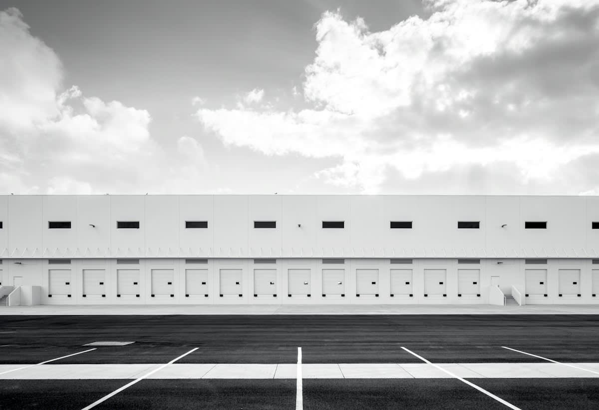 Modern logistics warehouse exterior with asphalt