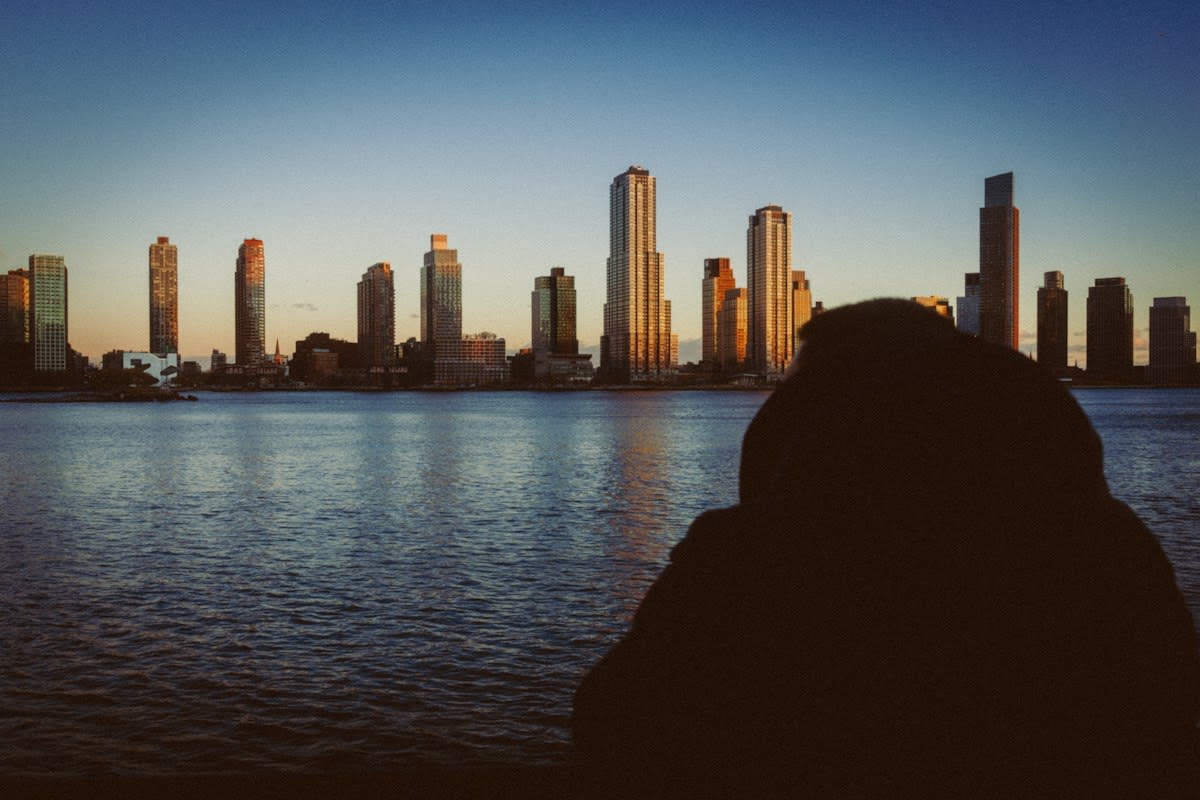A lonely person looking at a city skyline