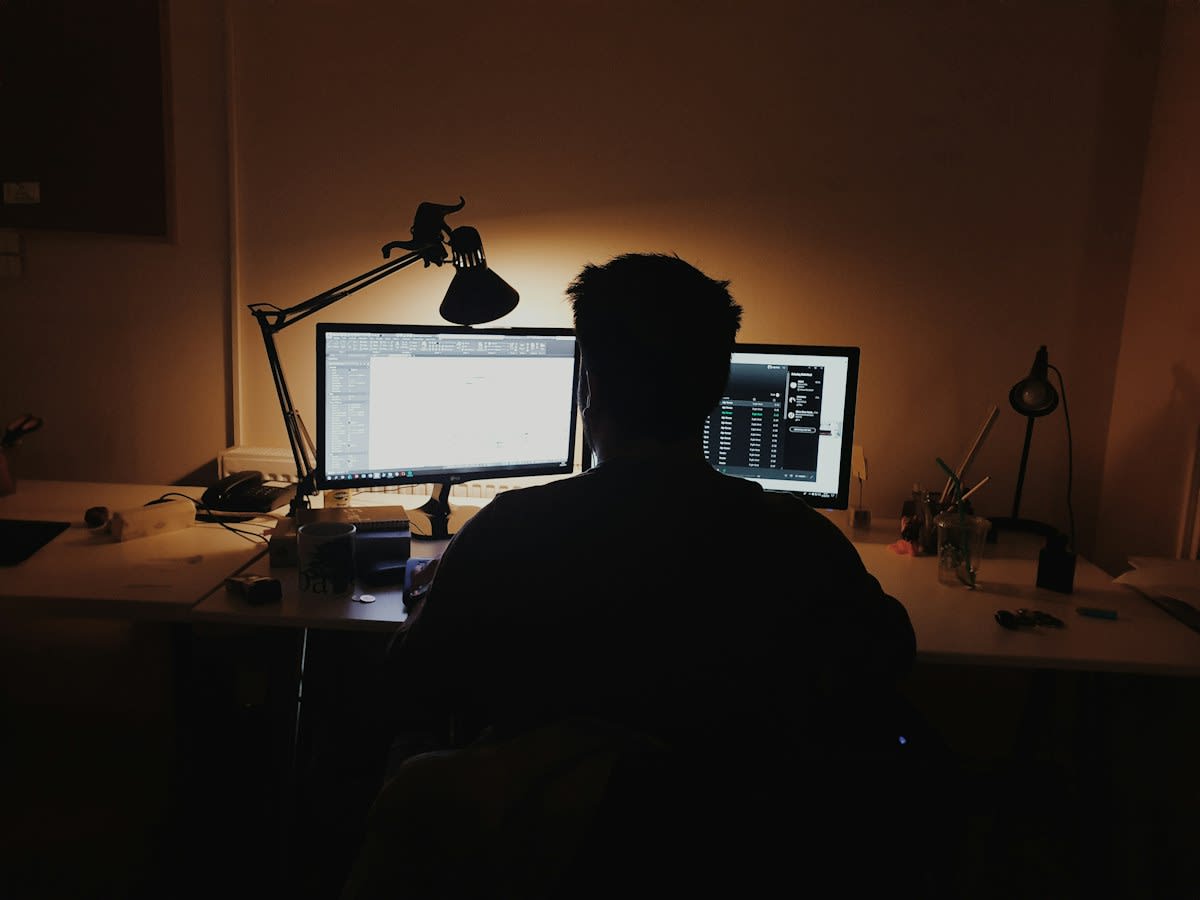 person staring at computer screen blue light