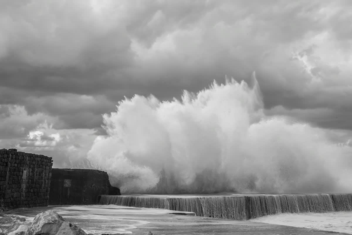 concrete seawall crashing waves