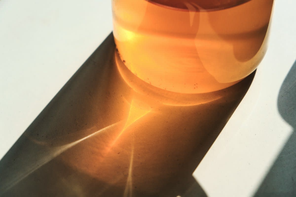 Glass of water with lemon and sunlight