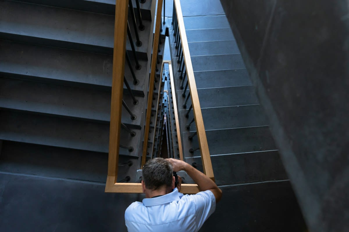 Stressed professional looking at a corporate ladder