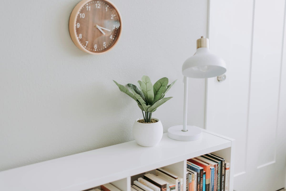 Minimalist workspace with a clock and a notebook