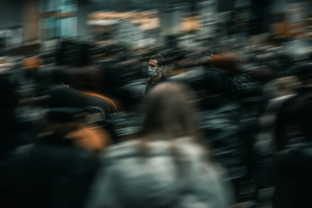 abstract image of a person standing against a crowd