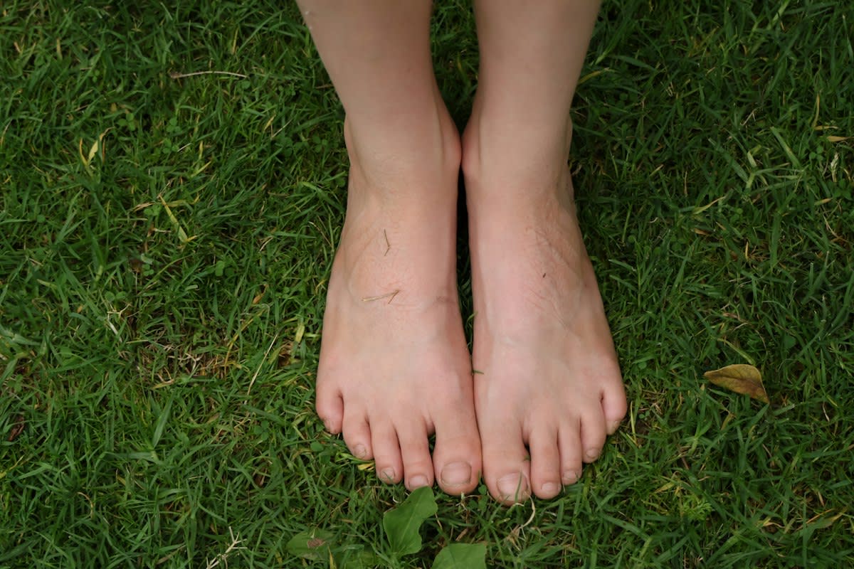Bare feet on green grass