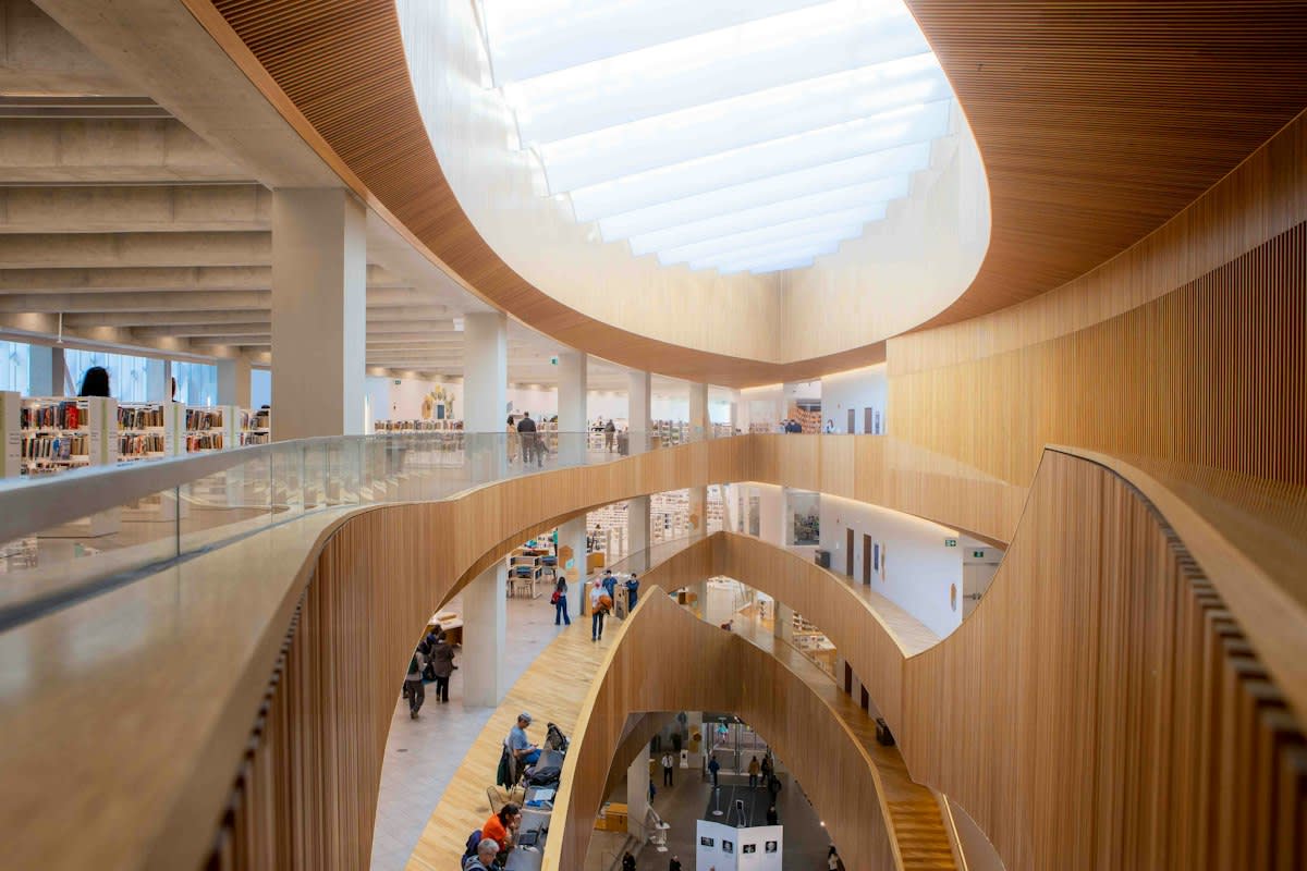 Modern public library interior with people reading