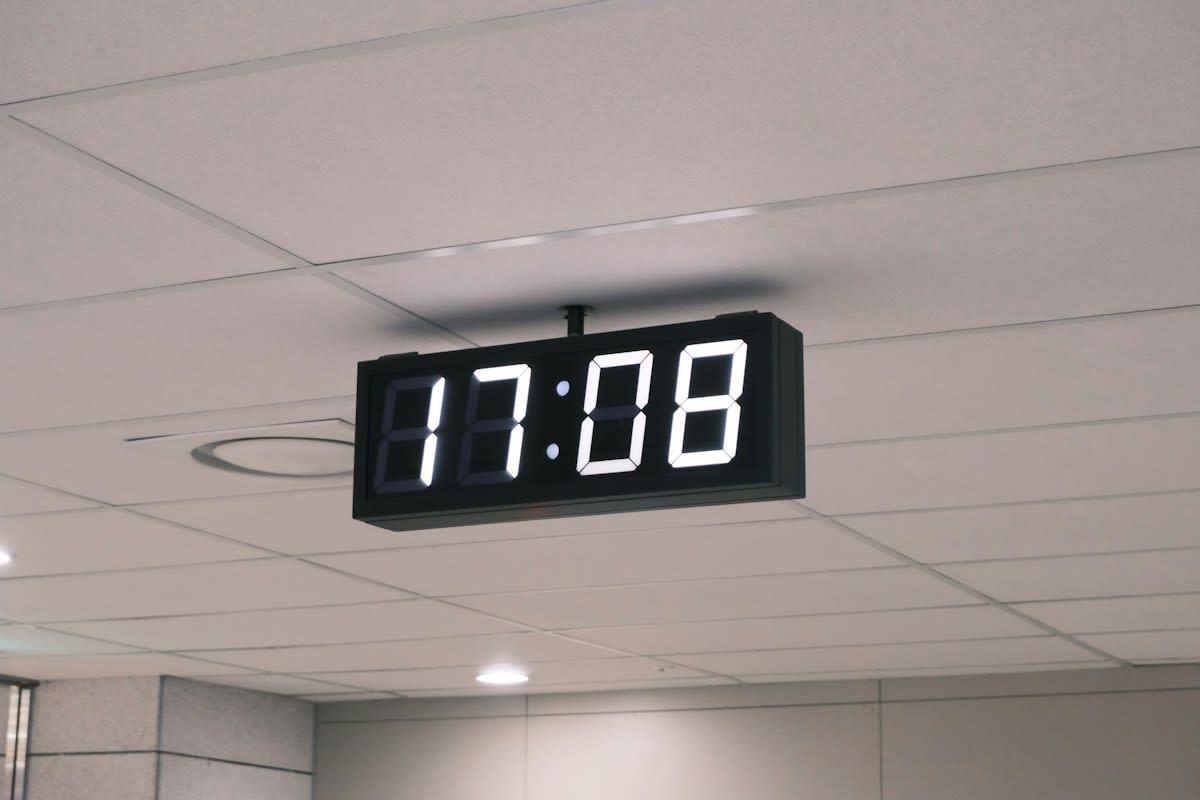 digital clock and office papers