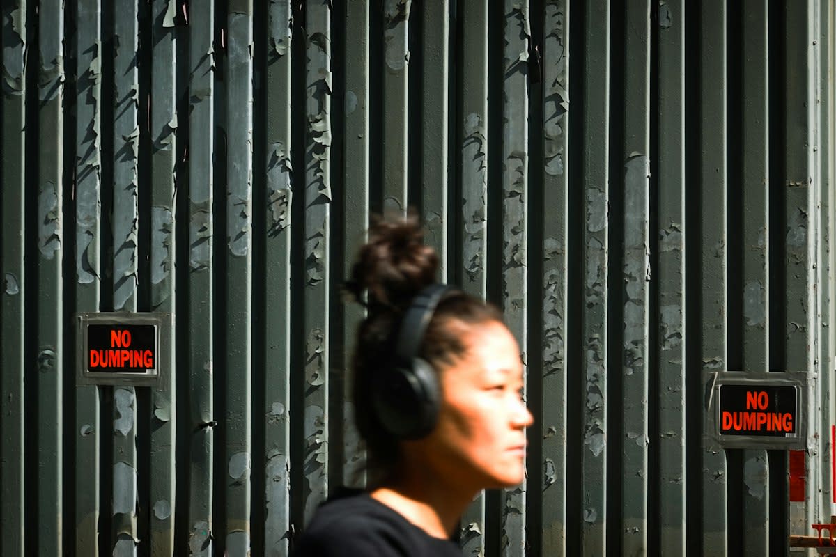 Person wearing noise-canceling headphones in a public space