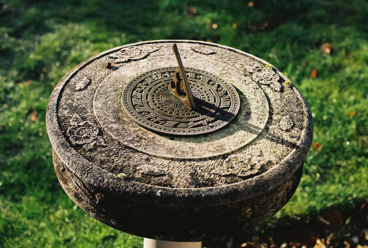 Ancient stone sundial in a garden