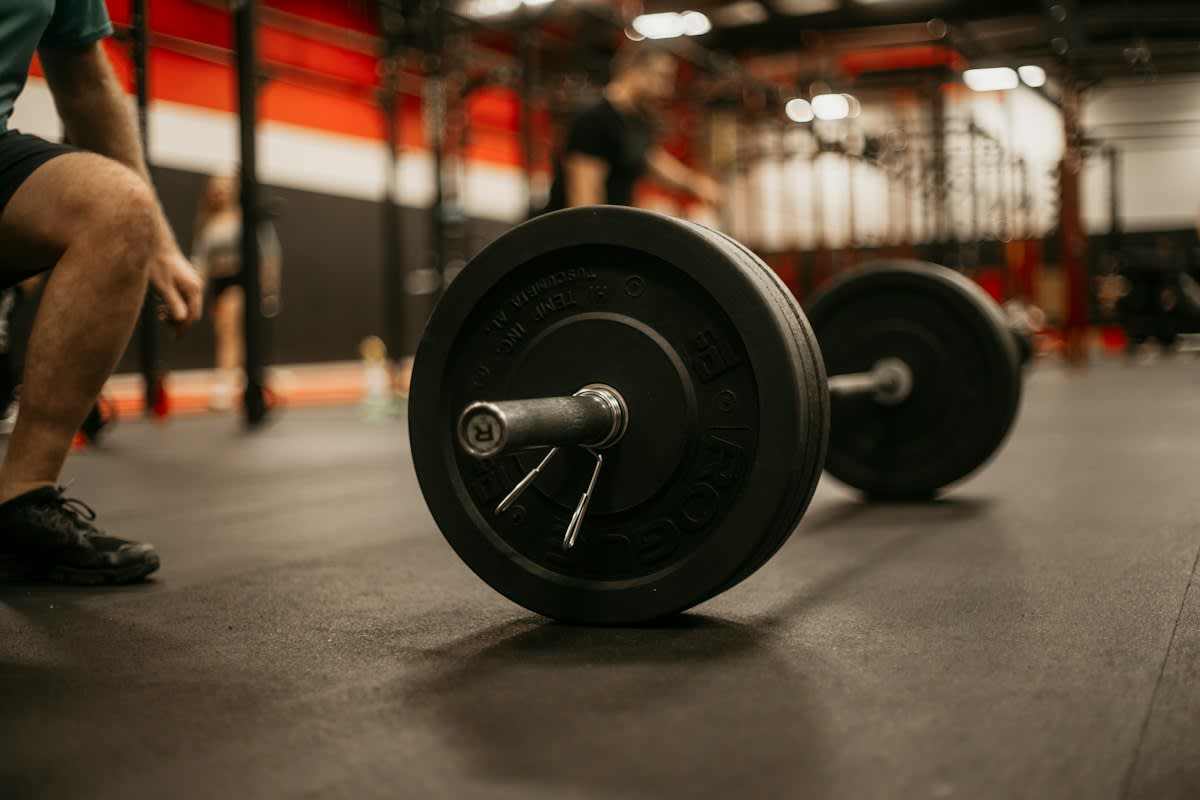 Weightlifter resting between sets in a gym
