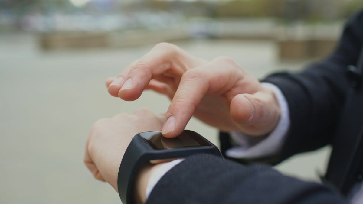 Athlete looking at a fitness tracker on their wrist