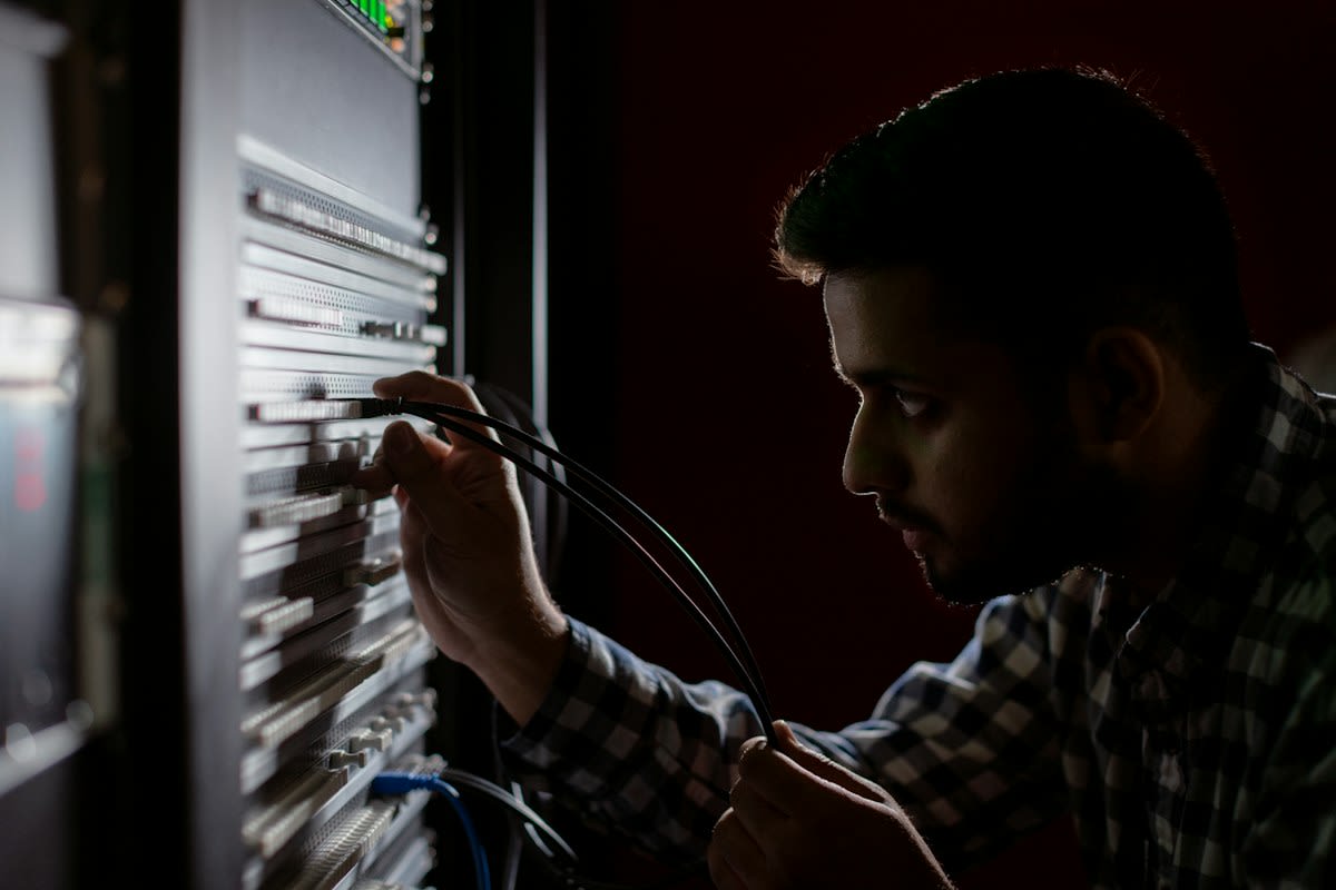 Technician cleaning immersion cooled server