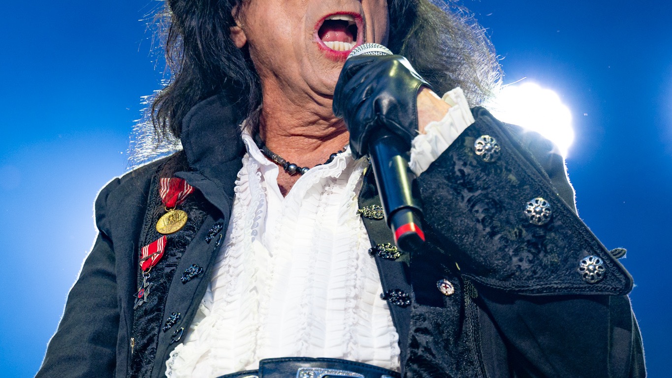 Alice Cooper performing live on stage in 2024, in theatrical horror-influenced stage costume