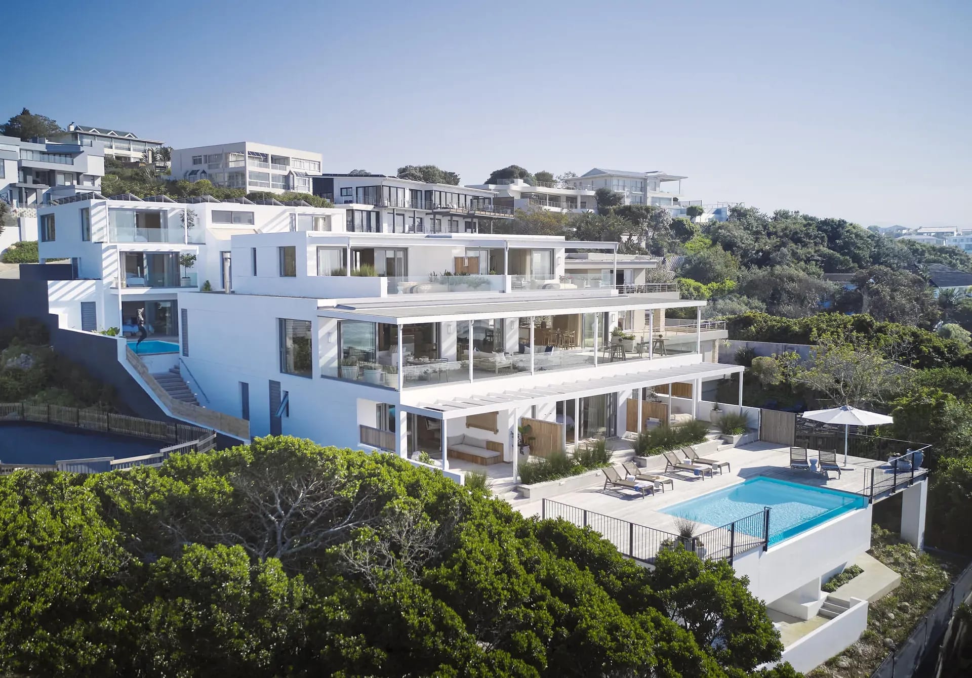 Modern seaside apartment complex at Walkers Beach with balconies and lush greenery