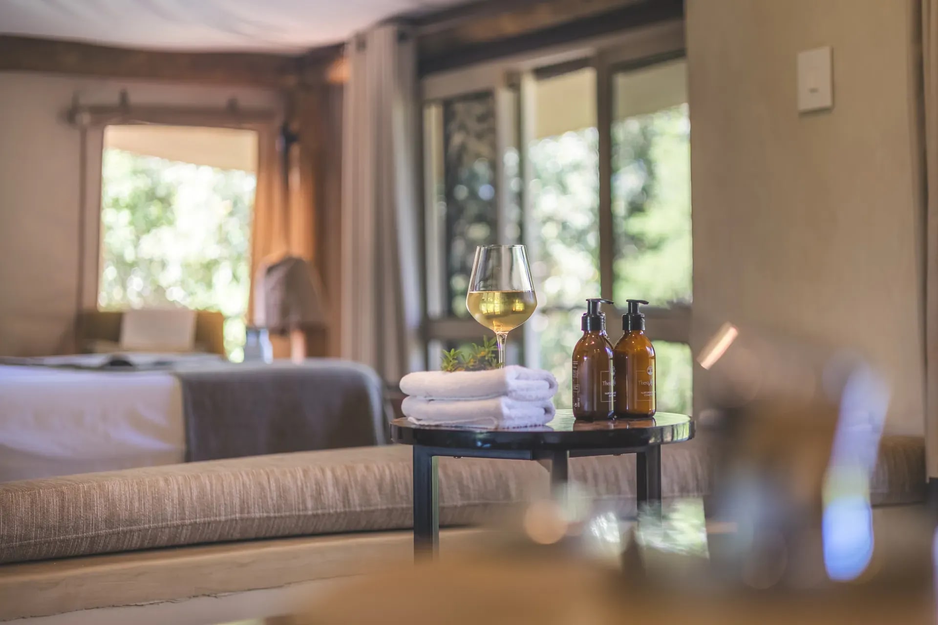 Marataba Safari Lodge – Luxury Tent bathroom, cozy with a glass of wine and neatly arranged towels.