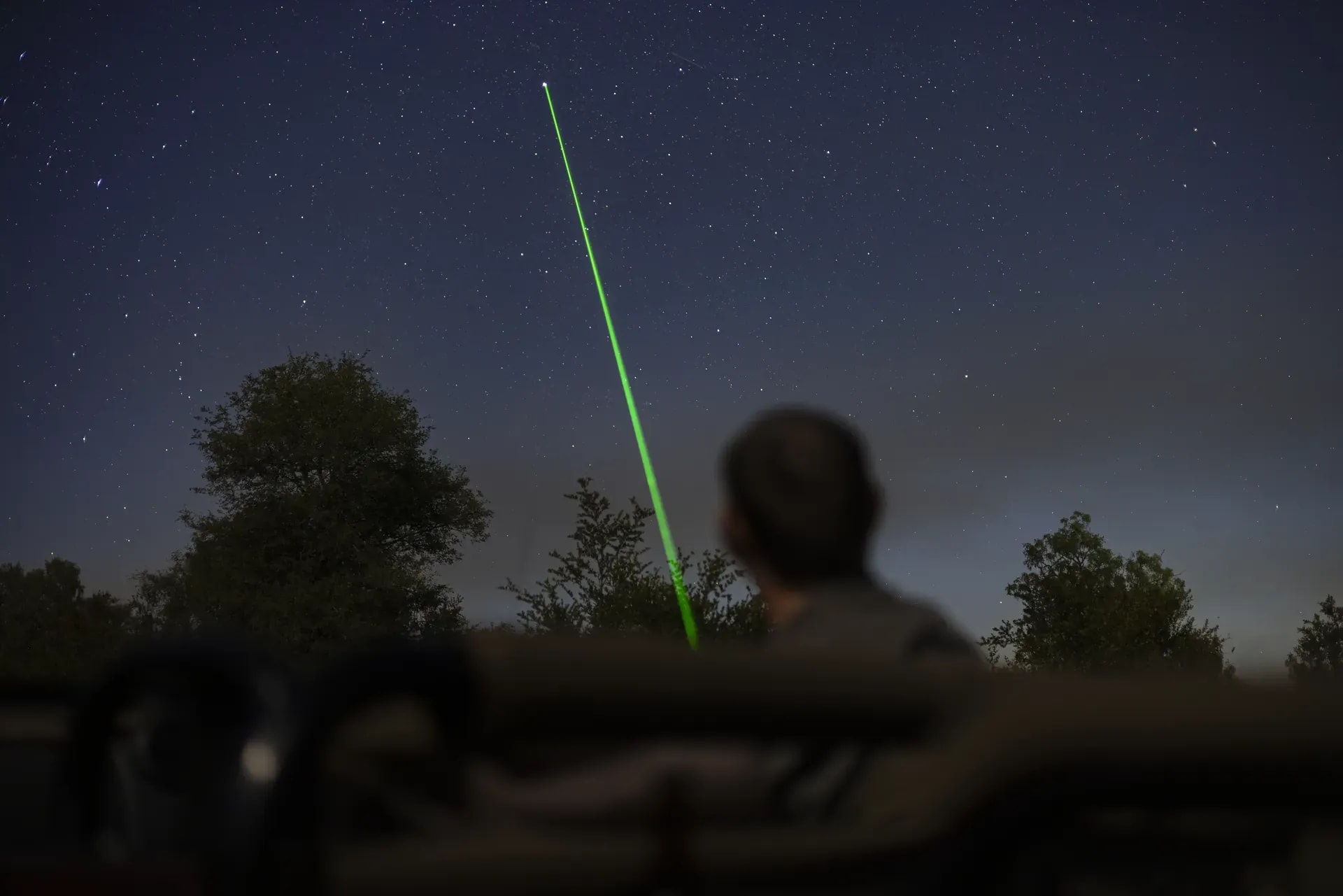 Field guide showing guests the stars with a laser pointer at Monwana Lodge, sharing expert knowledge.