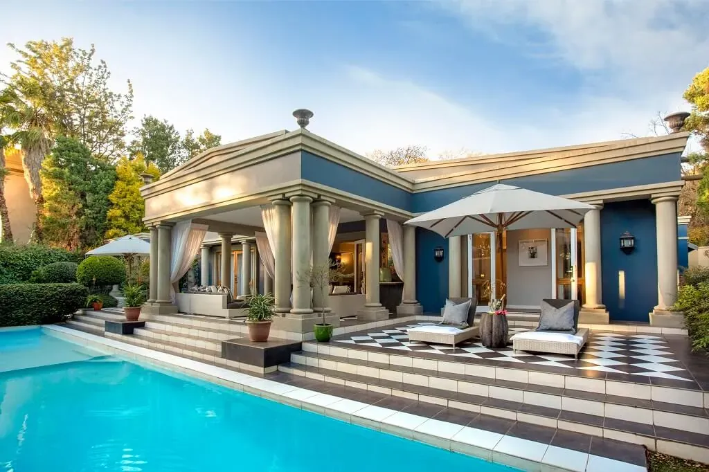 Luxury Fairlawns Boutique Hotel & Spa with grand columns, outdoor pool, and elegant courtyard