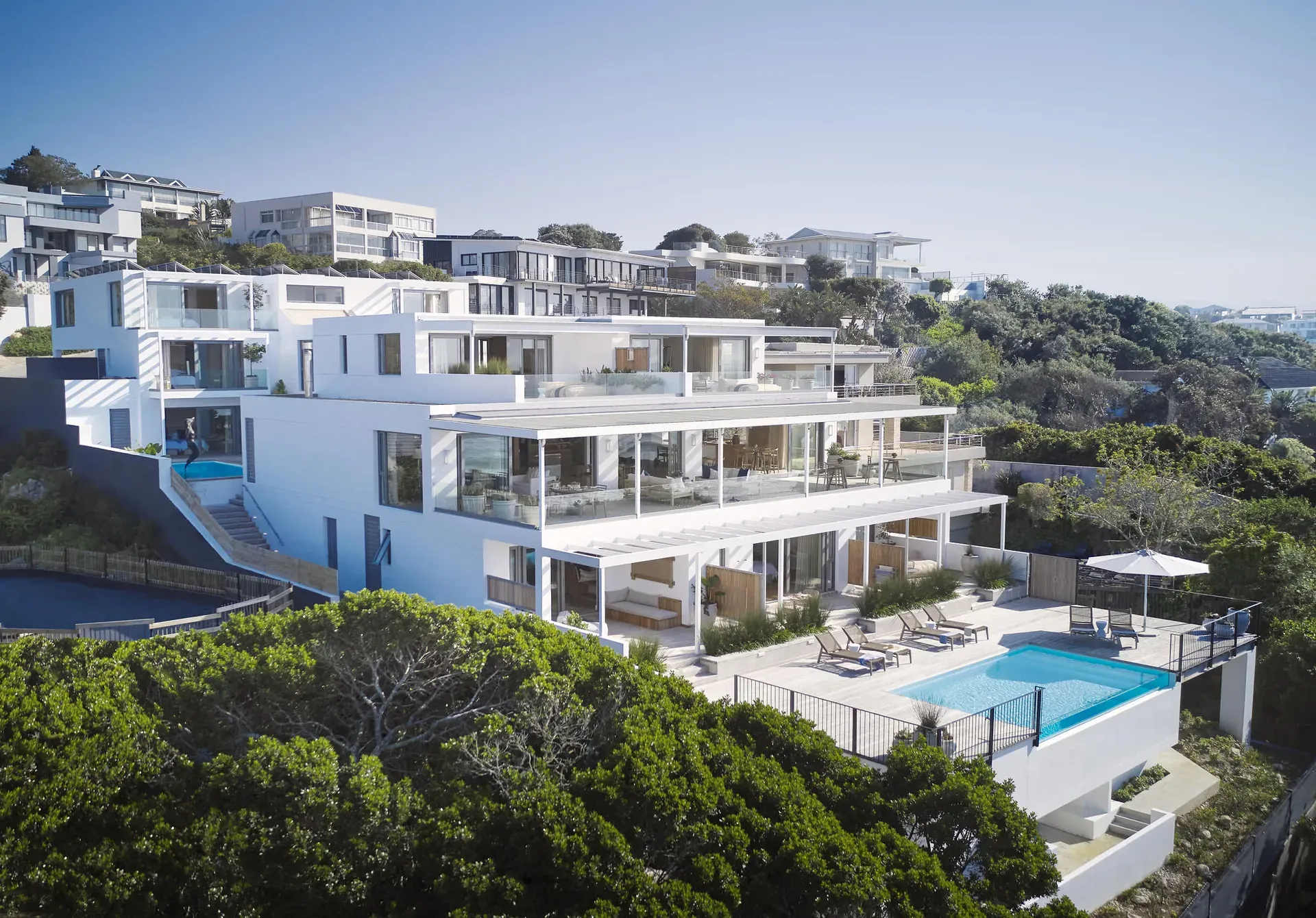 Modern seaside apartment complex at Walkers Beach with balconies and lush greenery