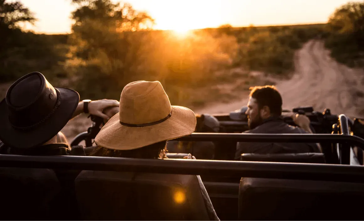 Traveler wearing a hat enjoying an evening safari at Marataba with golden sunset light
