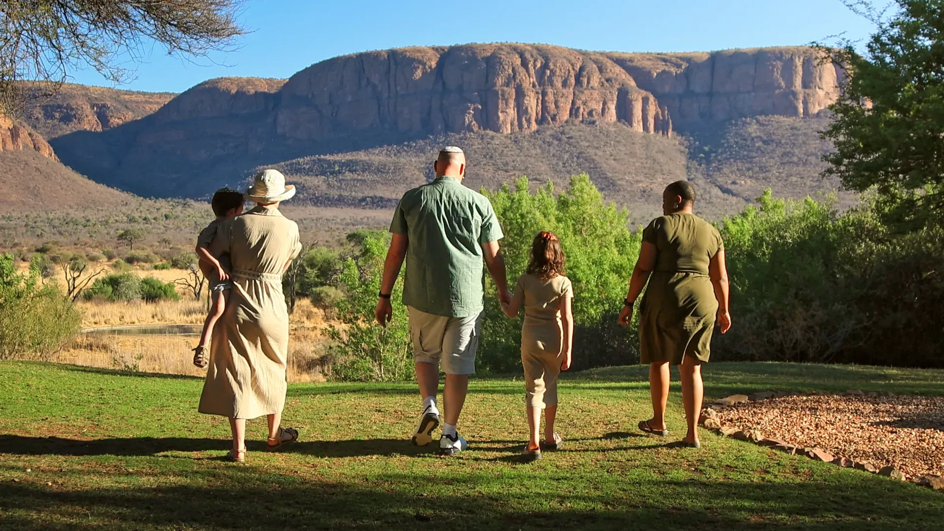 Marataba – Family walking into the distance with stunning natural views and mountains.