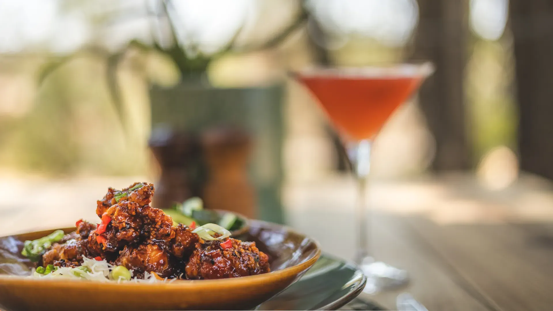 Plate of healthy food served with a cocktail at Monwana Lodge.