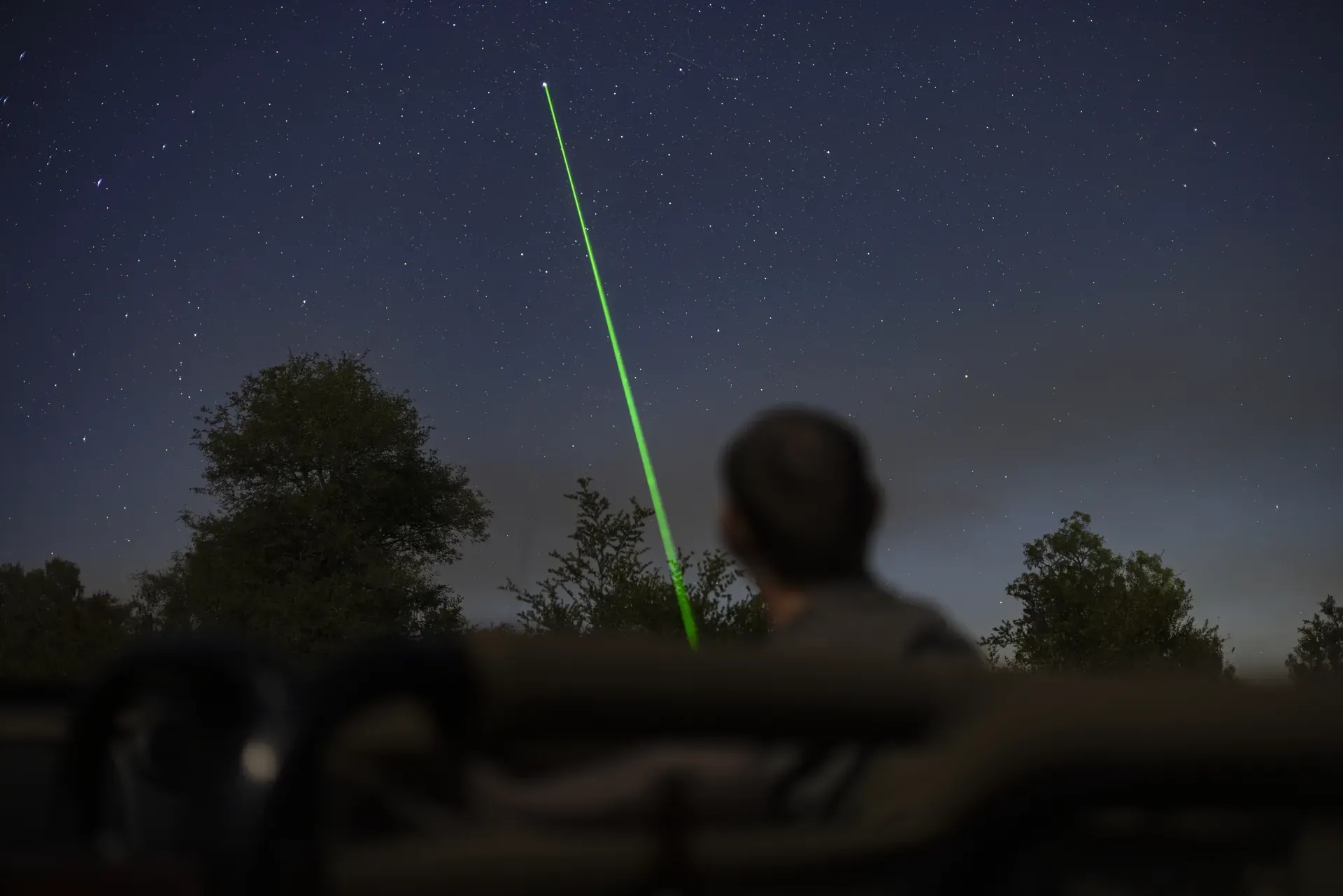 Field guide showing guests the stars with a laser pointer at Monwana Lodge, sharing expert knowledge.