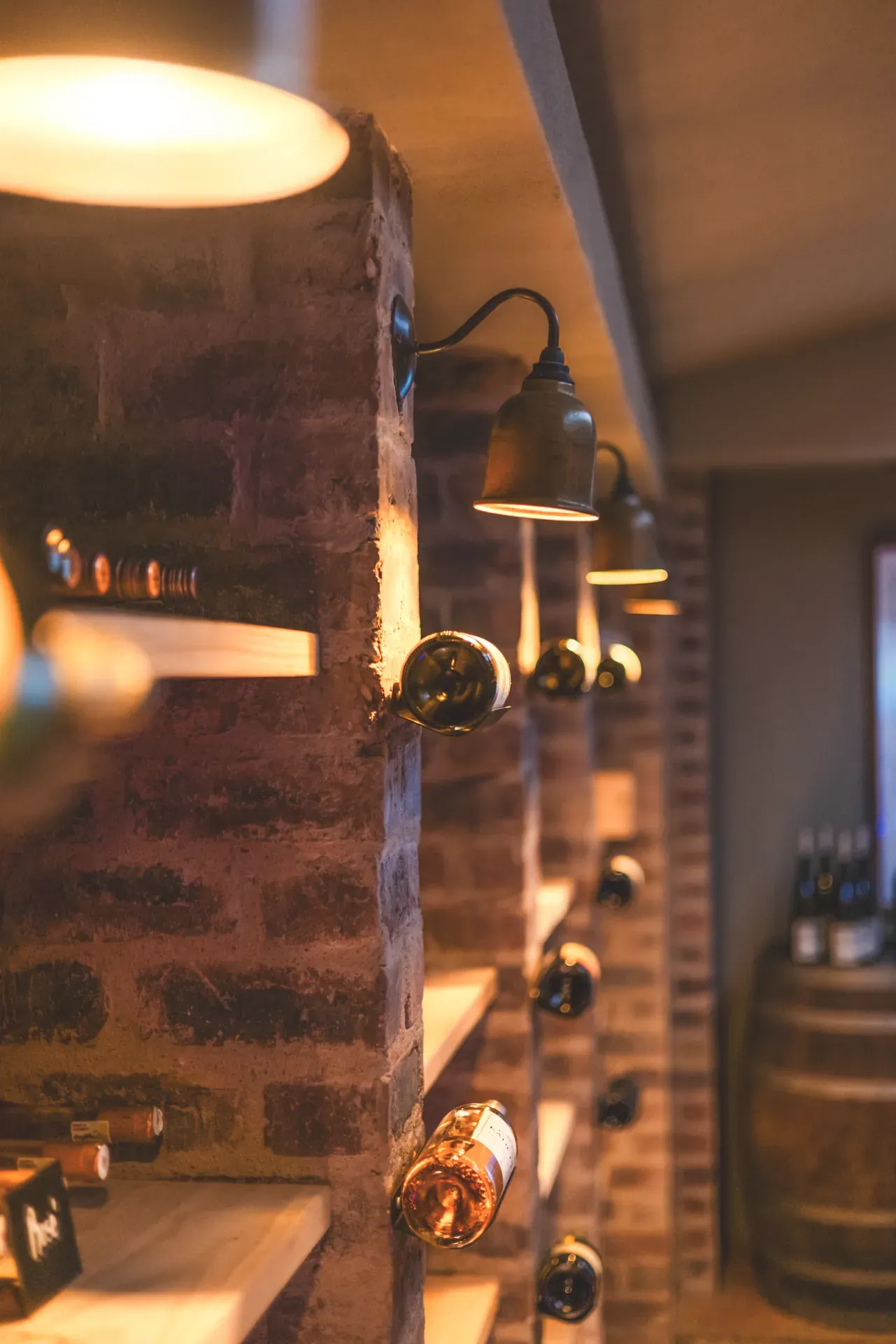 Fully stocked wine cellar at Monwana Lodge with bottles displayed.