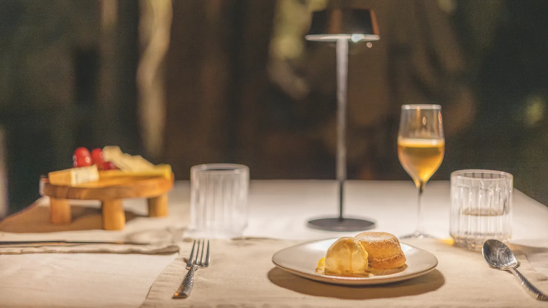 Food and wine pairing at Monwana Lodge, with a plate of food and wine displayed.