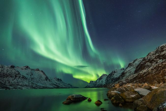 Picture shows vibrant green northern lights above Iceland.