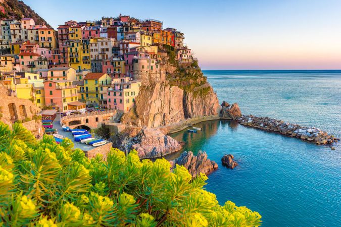 Picture shows a vibrant village, perched atop a cliff, on the sun drenched Amalfi Coast in Italy.