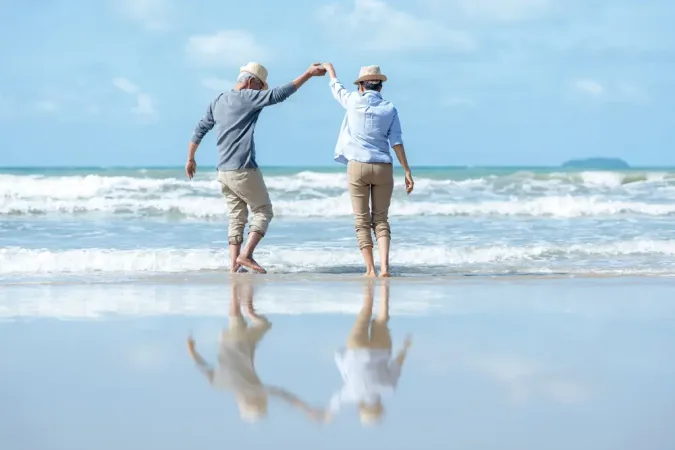 Senior couple dancing on the beach happy and relax time