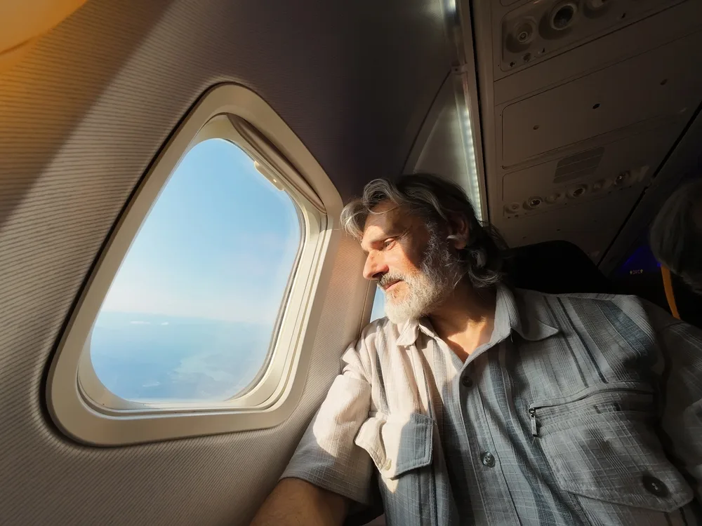 Man travelling from Australia on a long-haul flight - Travel Insurance