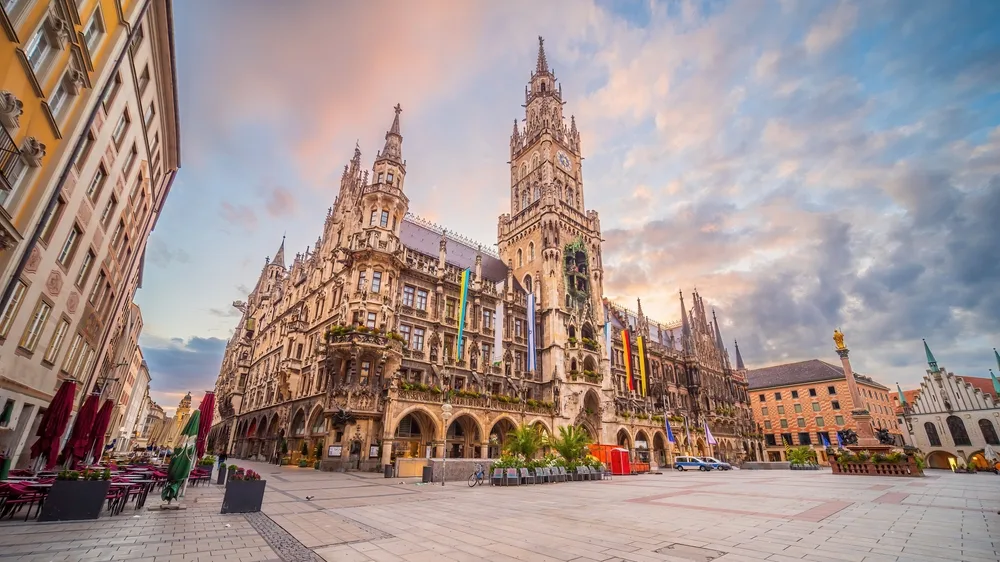 Munich Marienplatz featuring the New Town Hall (Neues Rathaus), with ornate Gothic architecture and clock tower at sunset in Munich, Germany.