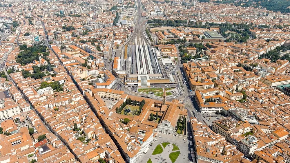 Aerial view of Firenze Santa Maria Novella train station in Florence, surrounded by historic buildings and terracotta rooftops