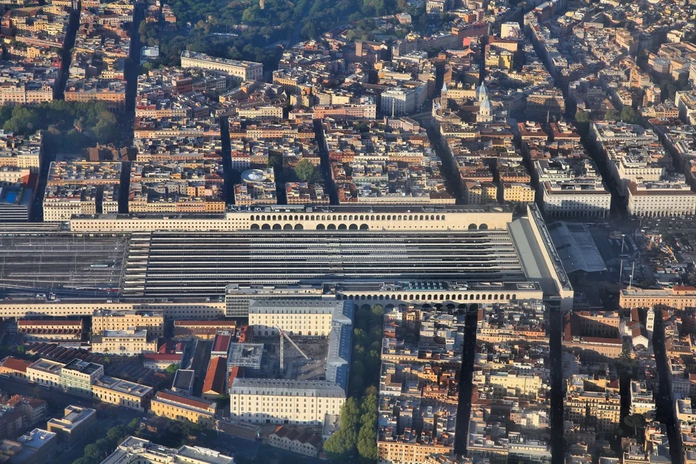 Aerial view of Roma Termini station in Rome, showing extensive rail platforms and surrounding historic city buildings