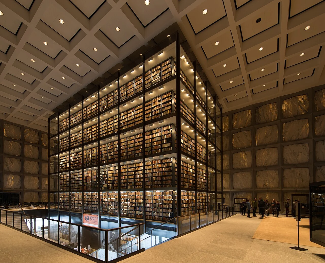 Beinecke Rare Book & Manuscript Library interior at Yale University, featuring a six-storey glass book tower and geometric marble walls.