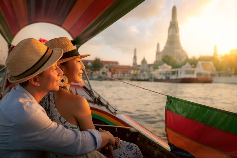 Picture shows a couple enjoying a romantic boat trip in Bangkok, Thailand. 