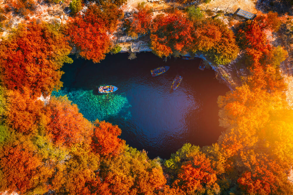 Melissani Cave with autumn colors. Famous Melissani lake on Kefalonia island, Karavomylos, Greece.