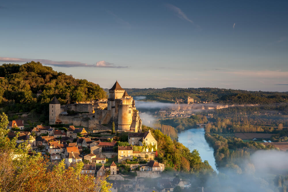 Chateau Castlenaud at sunrise with the Dordgne river and Chateau Beynac, France