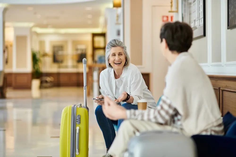 Couple laughing while they wait in an airport.