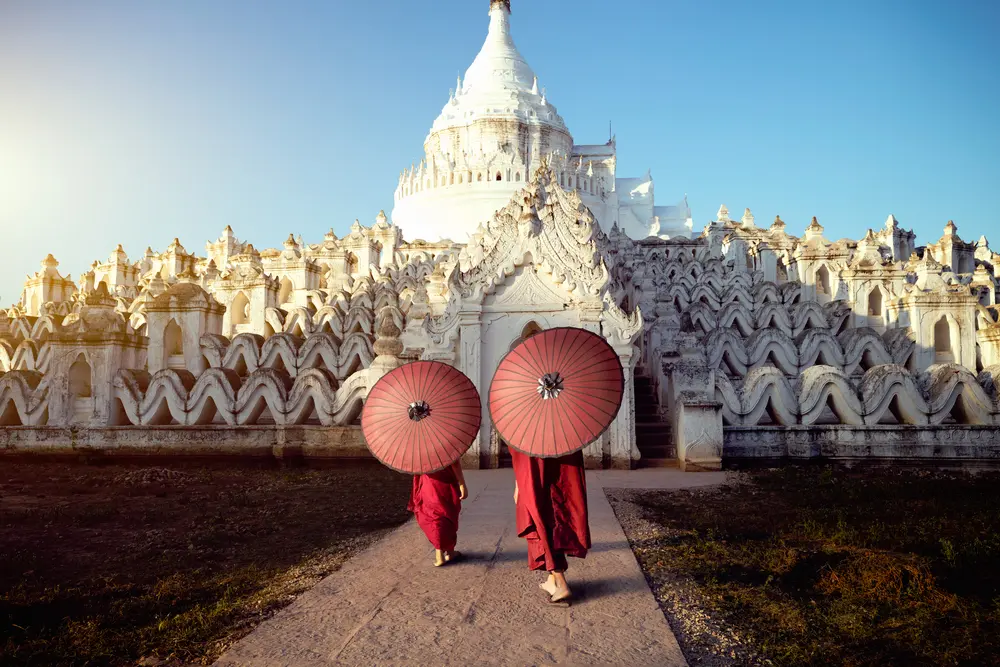 Novices under umbrellas at historic temple, Mingun, Mandalay, Myanmar