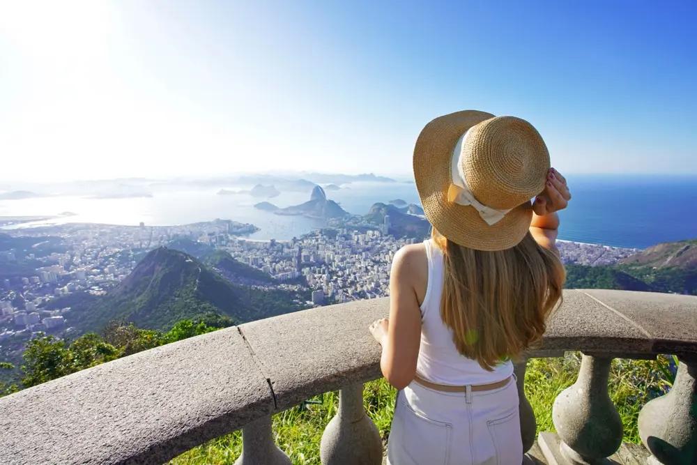 Traveler on Corcovado mountain looks at Guanabara Bay, Rio de Janeiro, Brazil.