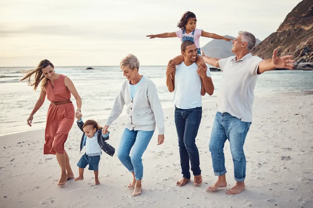 A family enjoys a relaxing stroll on the beach.