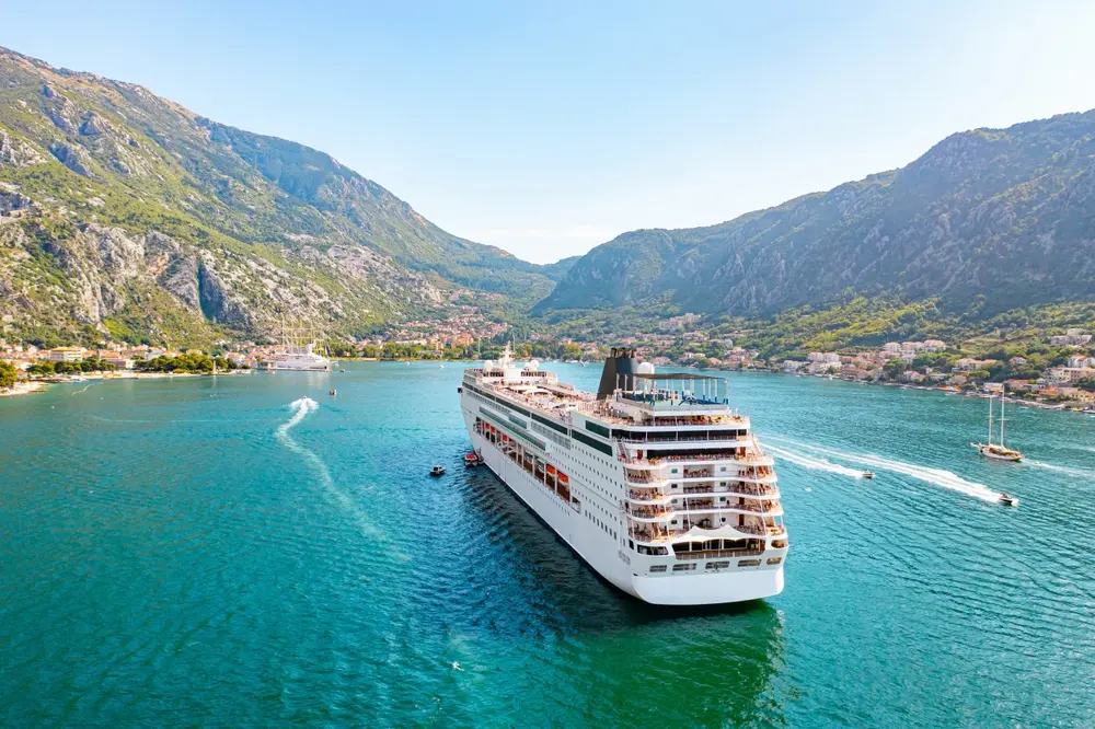 Cruise ship approaching a port, close aerial view, Montenegro.