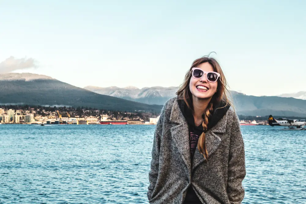 A smiling solo female traveller, enjoying her holiday. 