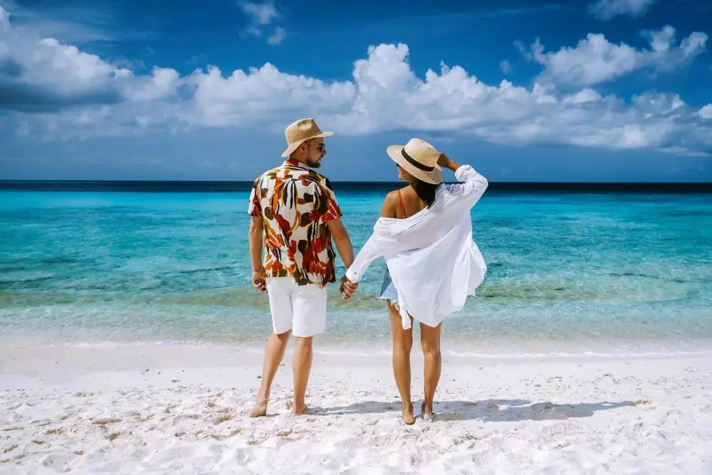 Happy couple enjoying their holiday on a pristine beach.