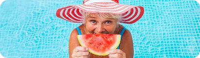 lady in pool eating watermelon